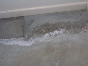 Deterioration to concrete slab from rising damp